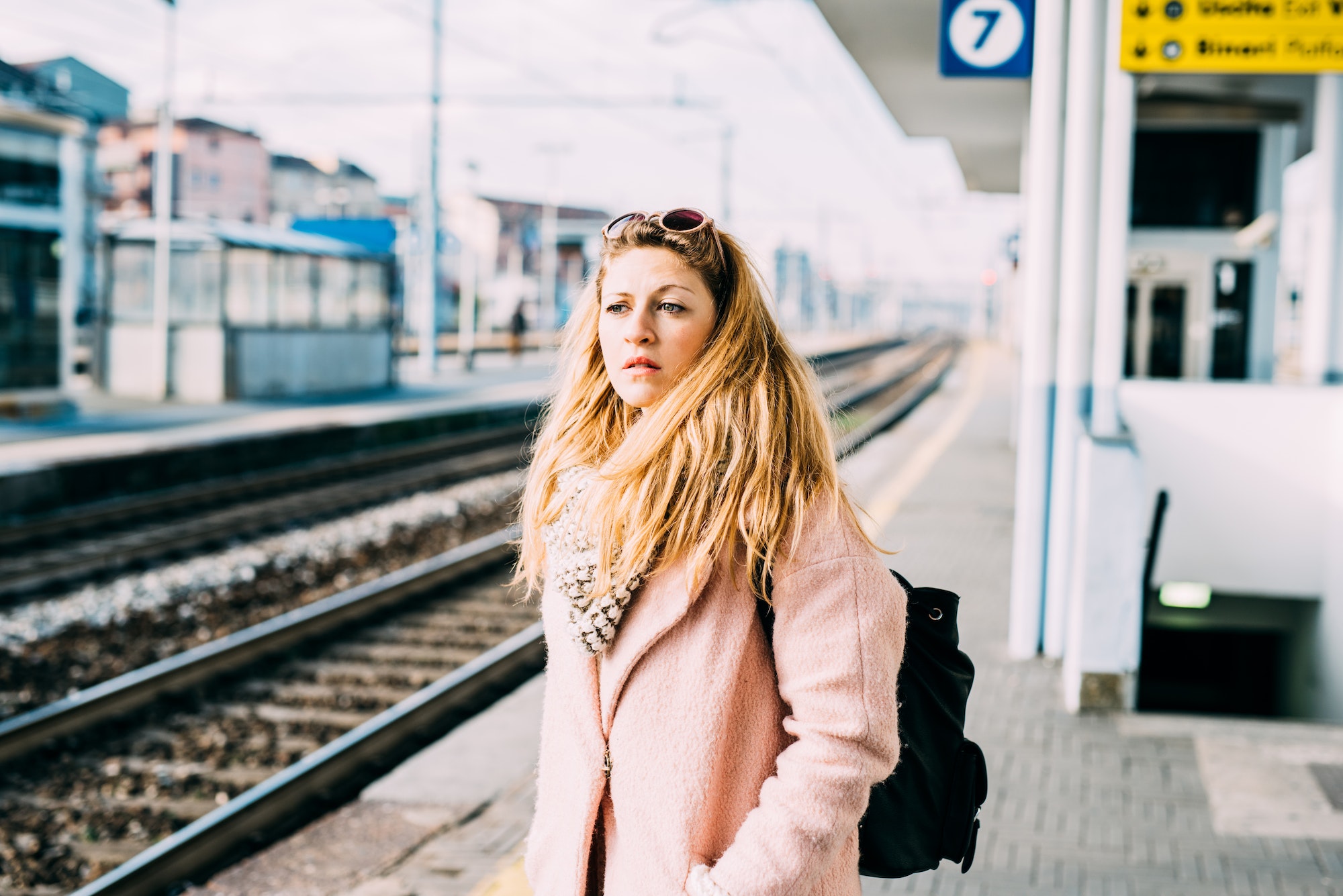 Young woman at the train station waiting for train